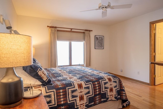 bedroom with light hardwood / wood-style flooring and ceiling fan