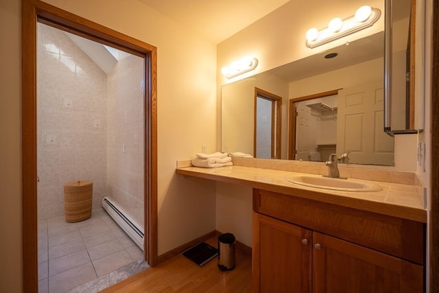 bathroom with baseboard heating, tile patterned flooring, and vanity