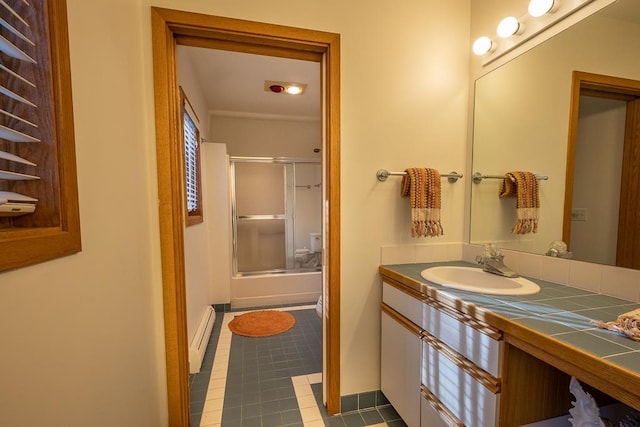 bathroom with tile patterned flooring, vanity, baseboard heating, and walk in shower