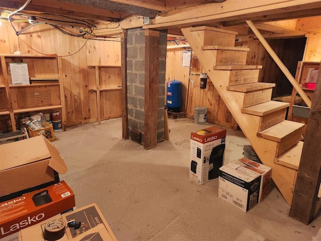 basement featuring wood walls