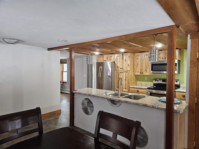 kitchen featuring light brown cabinetry, pendant lighting, stainless steel appliances, and sink