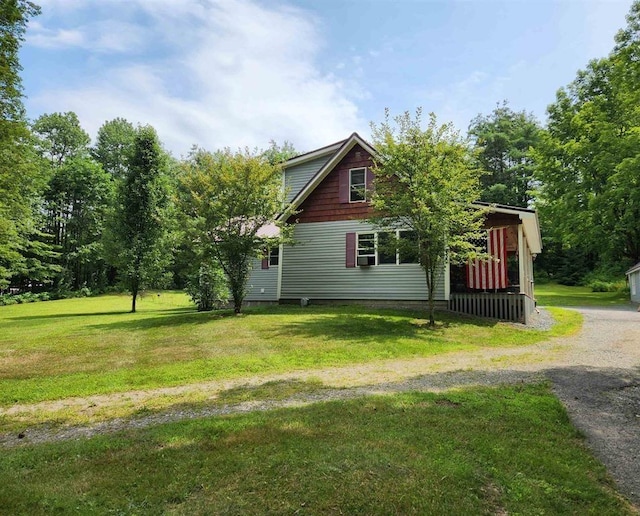 view of side of home featuring a lawn