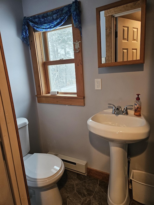 bathroom with toilet and a baseboard heating unit