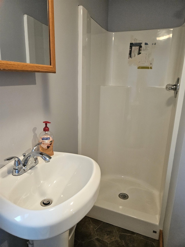 bathroom with a shower, tile patterned floors, and sink