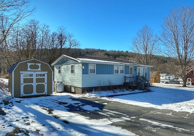 view of front of property with a shed