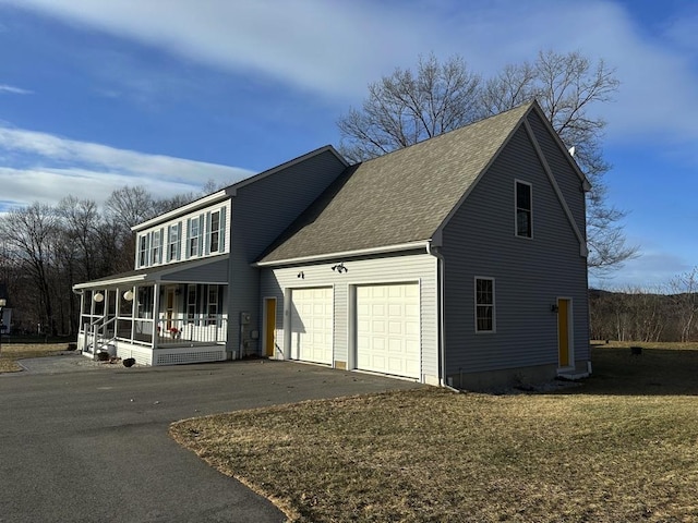 exterior space with a garage, covered porch, driveway, and a shingled roof