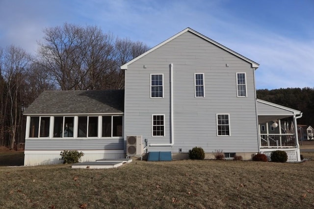 rear view of house featuring a porch and a yard