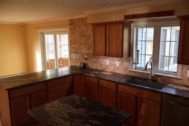 kitchen with a peninsula, a sink, ornamental molding, stainless steel dishwasher, and brown cabinetry