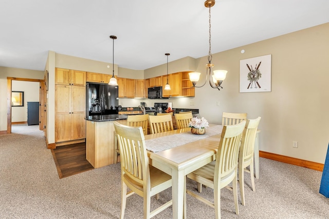 dining room featuring carpet floors and a notable chandelier