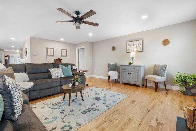 living room featuring ceiling fan and light hardwood / wood-style flooring