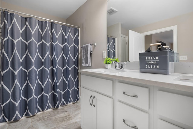 bathroom featuring vanity and a shower with shower curtain