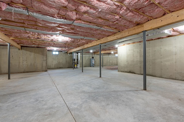 basement featuring heating unit and water heater