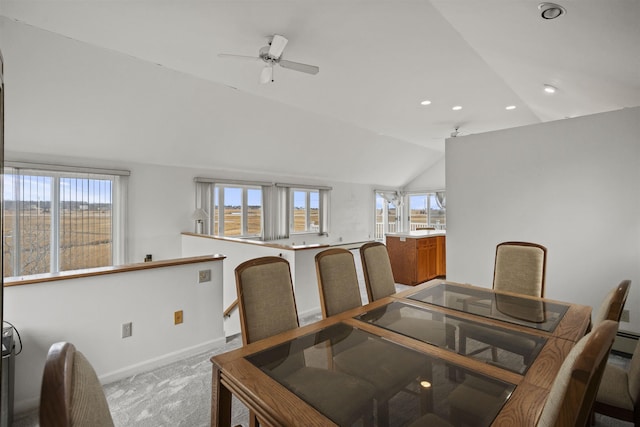 carpeted dining room featuring a healthy amount of sunlight, ceiling fan, and lofted ceiling
