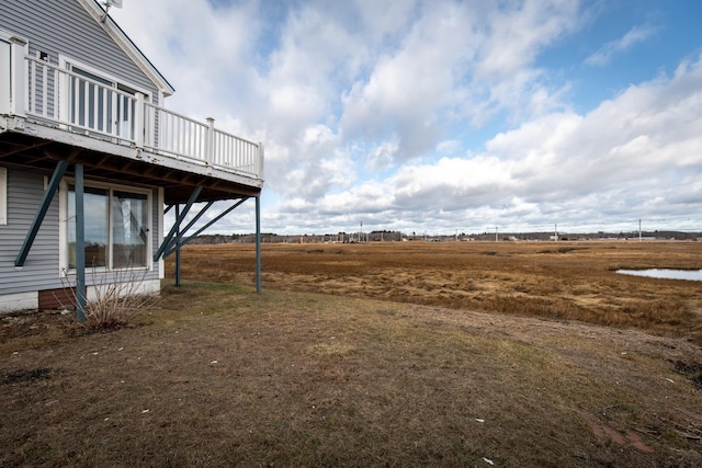 view of yard featuring a rural view and a deck