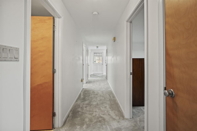 hall with light colored carpet