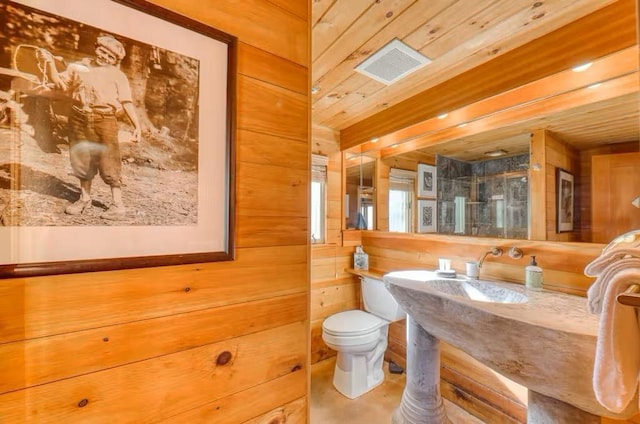 bathroom featuring toilet, wood ceiling, and wood walls