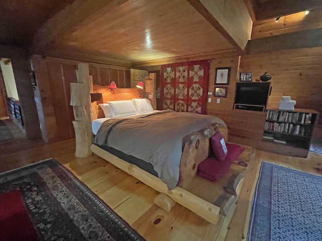 bedroom with hardwood / wood-style flooring, wooden walls, and wood ceiling