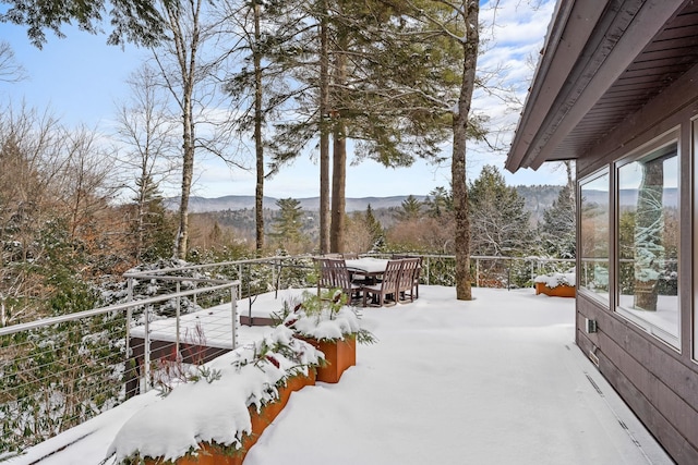 yard layered in snow featuring a mountain view