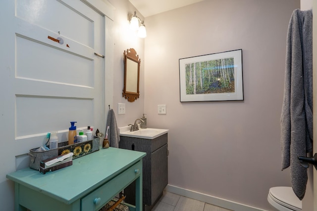 bathroom featuring tile patterned flooring, vanity, and toilet