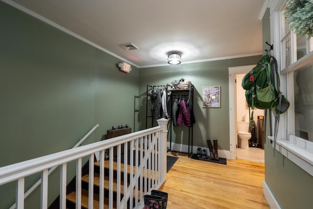 hallway featuring hardwood / wood-style flooring and ornamental molding