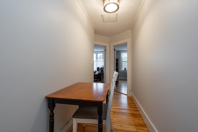 corridor featuring crown molding and wood-type flooring