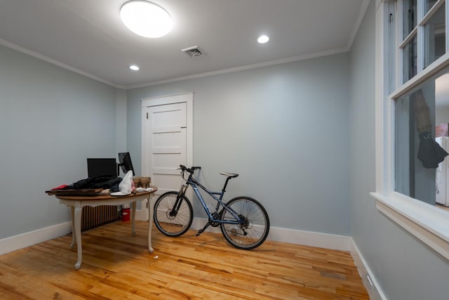 misc room featuring light wood-type flooring and ornamental molding