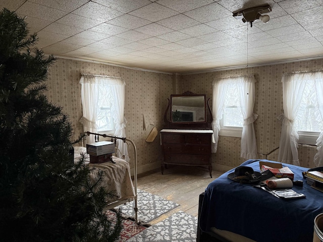 bedroom featuring hardwood / wood-style floors and multiple windows