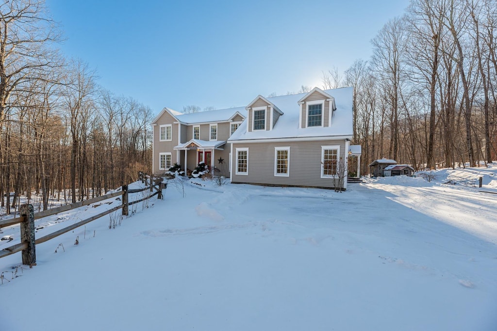 view of snow covered back of property