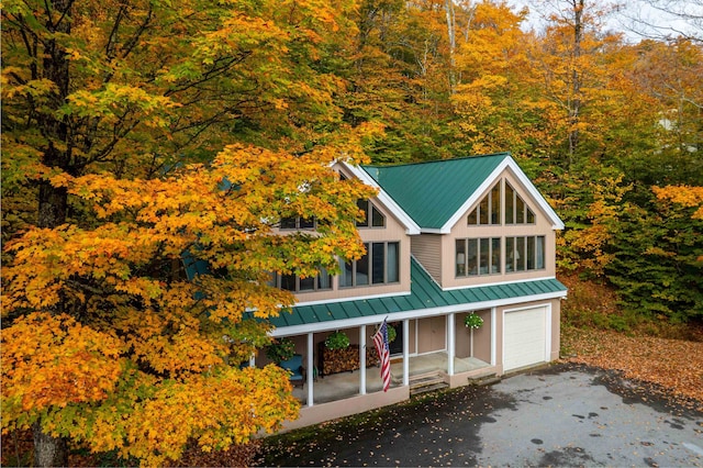 view of front of property featuring a porch and a garage