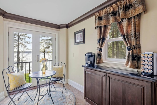 interior space featuring light tile patterned floors, french doors, and ornamental molding