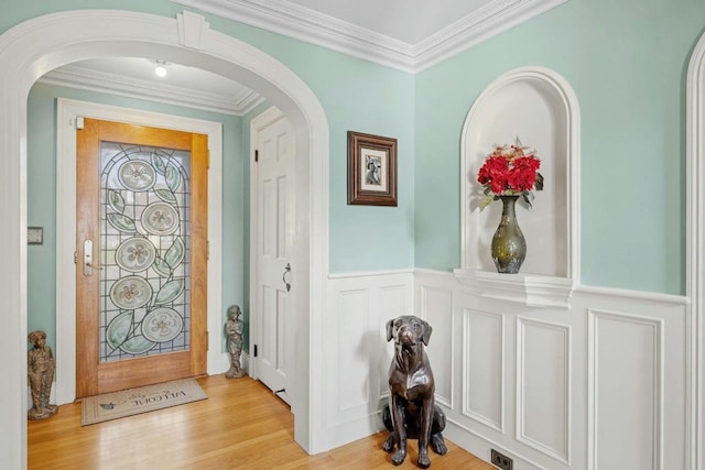 foyer featuring light hardwood / wood-style floors and crown molding