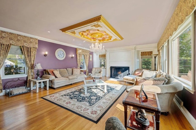 living room featuring hardwood / wood-style floors, crown molding, and a notable chandelier