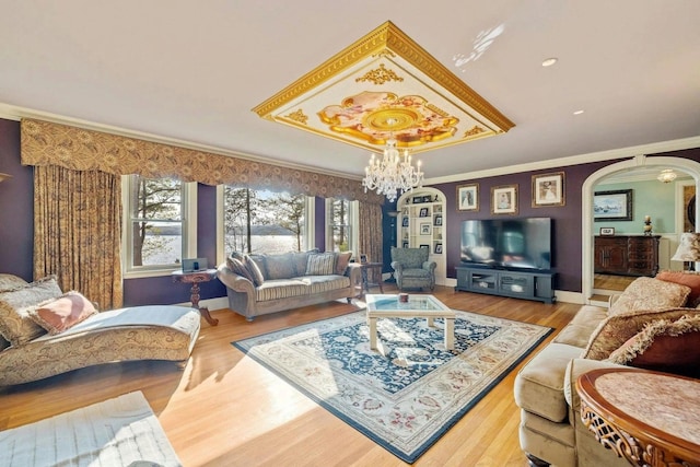 living room with ornamental molding, a chandelier, and hardwood / wood-style floors