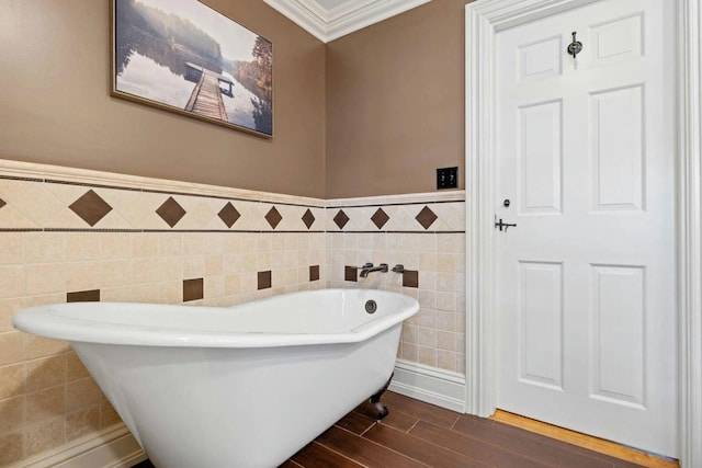 bathroom featuring tile walls, a bathing tub, and crown molding