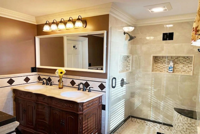 bathroom featuring ornamental molding, tile walls, a shower with shower door, and vanity