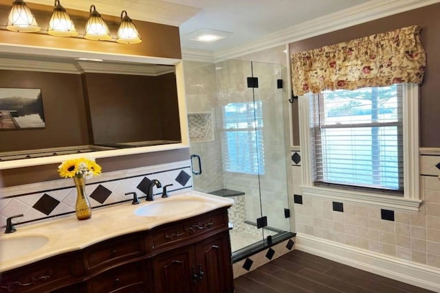 bathroom with an enclosed shower, vanity, and ornamental molding