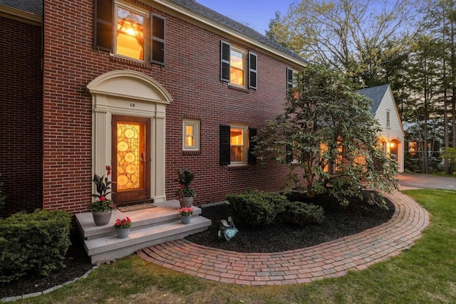 view of exterior entry at dusk