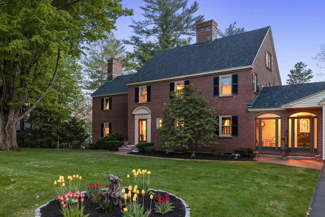 colonial-style house with a lawn