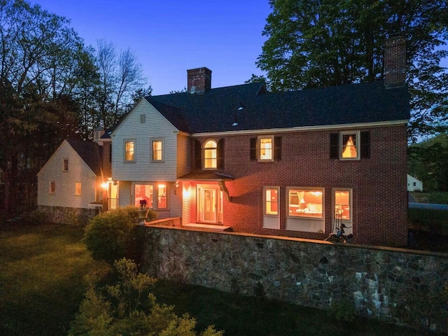 view of back house at dusk