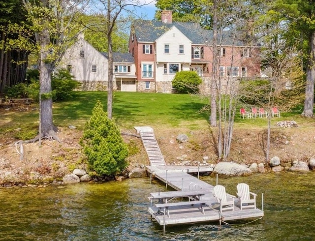 view of dock featuring a yard and a water view