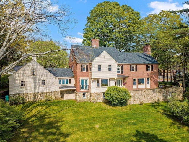 rear view of property with a yard