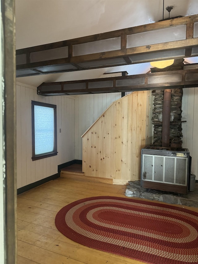 basement featuring wood walls and hardwood / wood-style floors