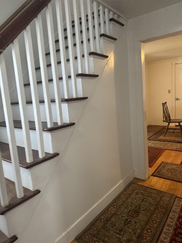 stairs featuring hardwood / wood-style flooring