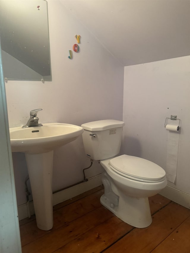 bathroom featuring toilet, vaulted ceiling, and hardwood / wood-style flooring