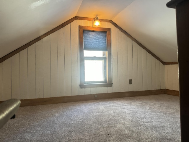 additional living space featuring lofted ceiling and carpet floors