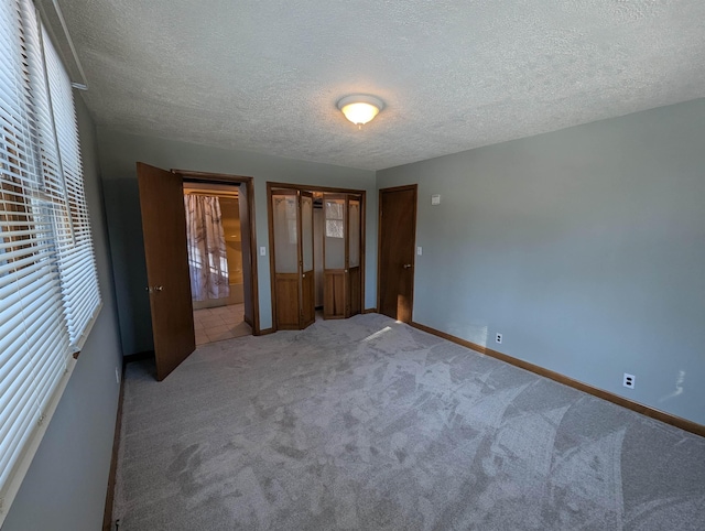 unfurnished bedroom featuring a textured ceiling and carpet floors