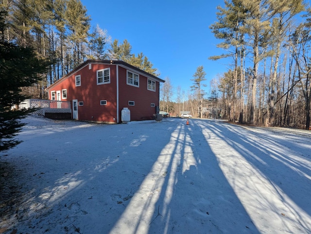 view of snow covered exterior with a deck