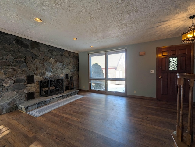 unfurnished living room with dark hardwood / wood-style flooring, a fireplace, and a textured ceiling