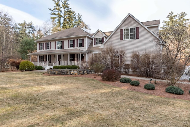 view of front of property featuring covered porch and a front yard