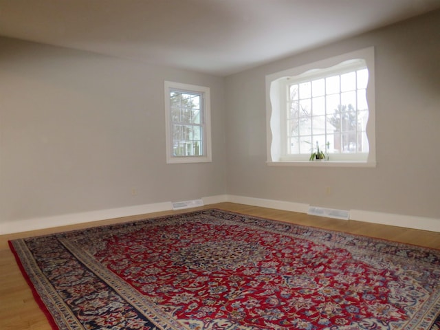 unfurnished room with hardwood / wood-style flooring